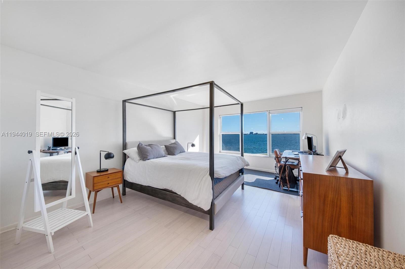 11111 Biscayne Boulevard, Unit 2D Miami, FL 33181 - Photo 13 of 26 a bedroom with furniture and a fireplace