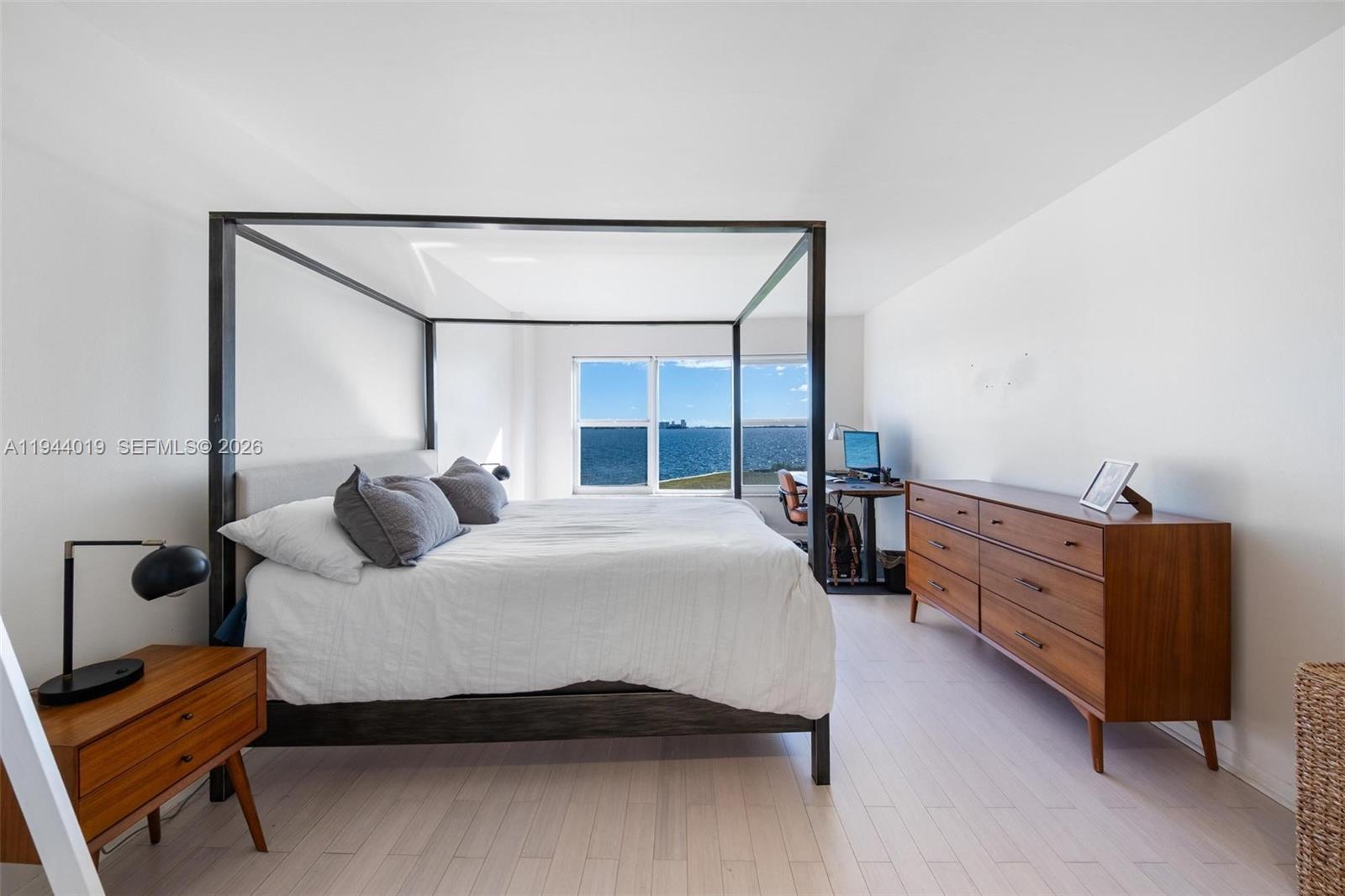 11111 Biscayne Boulevard, Unit 2D Miami, FL 33181 - Photo 14 of 26 a bedroom with a bed and a dresser