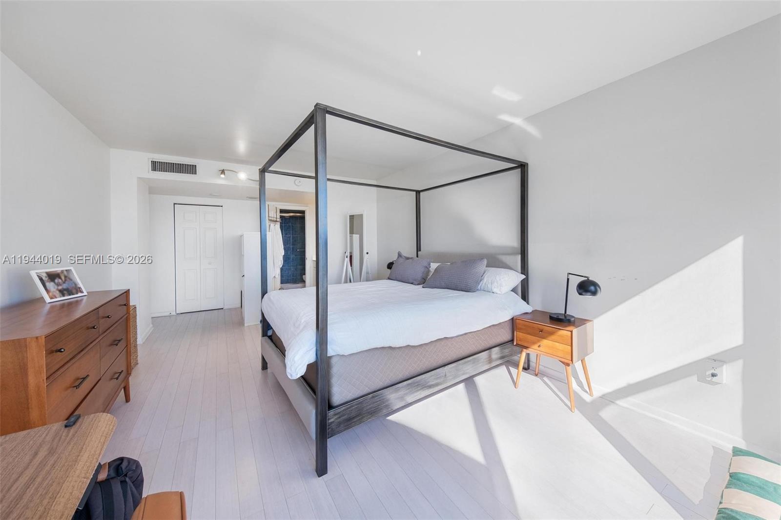 11111 Biscayne Boulevard, Unit 2D Miami, FL 33181 - Photo 15 of 26 a bed room with a bed and a dresser