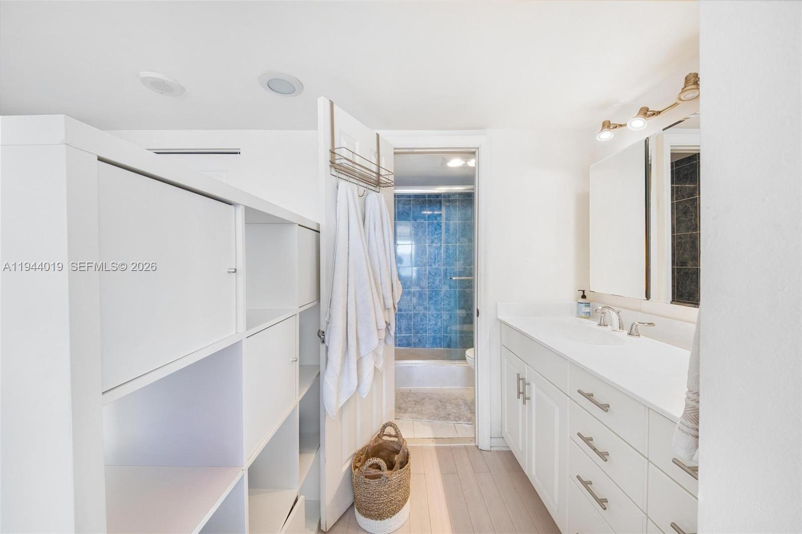 11111 Biscayne Boulevard, Unit 2D Miami, FL 33181 - Photo 17 of 26 a bathroom with a sink a toilet a mirror and shower