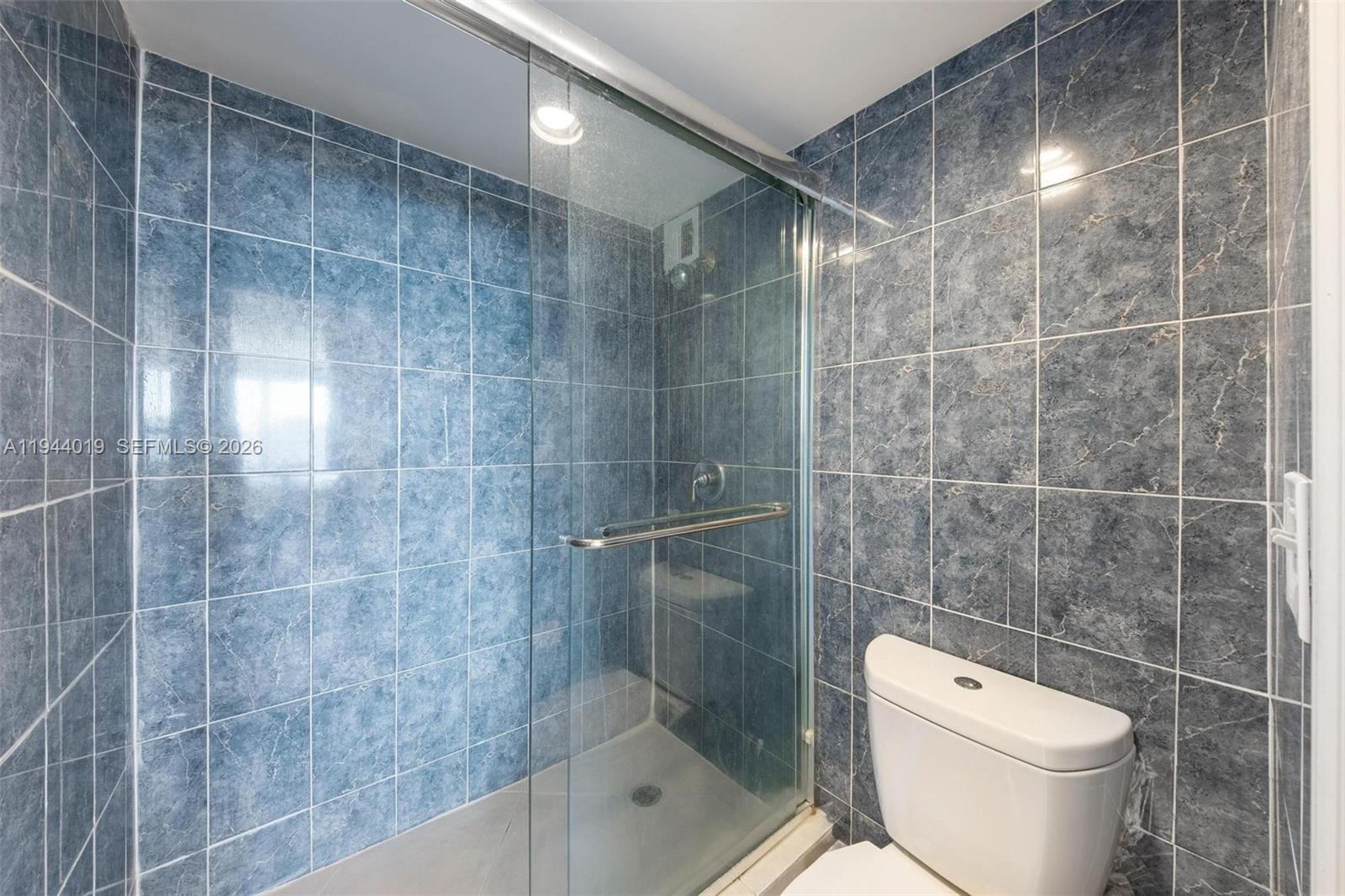 11111 Biscayne Boulevard, Unit 2D Miami, FL 33181 - Photo 18 of 26 a bathroom with a toilet and a shower