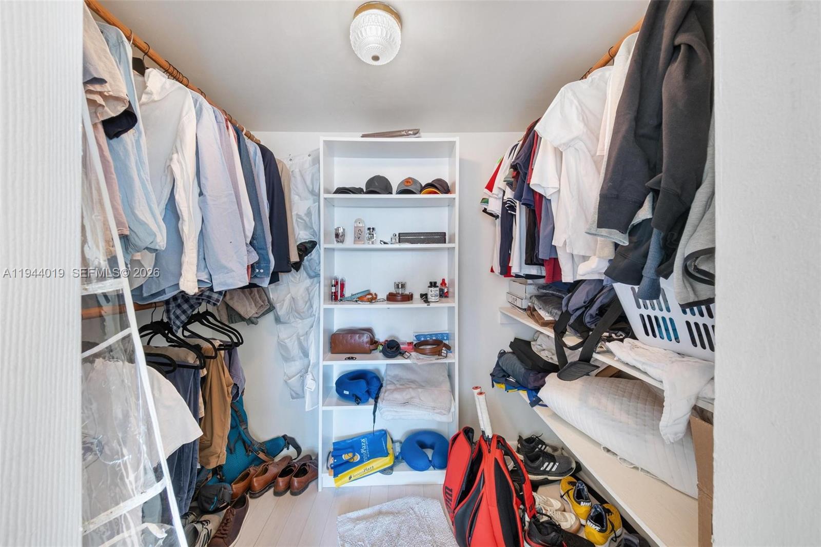 11111 Biscayne Boulevard, Unit 2D Miami, FL 33181 - Photo 19 of 26 a view of walk in closet with clothes shoes and a mirror