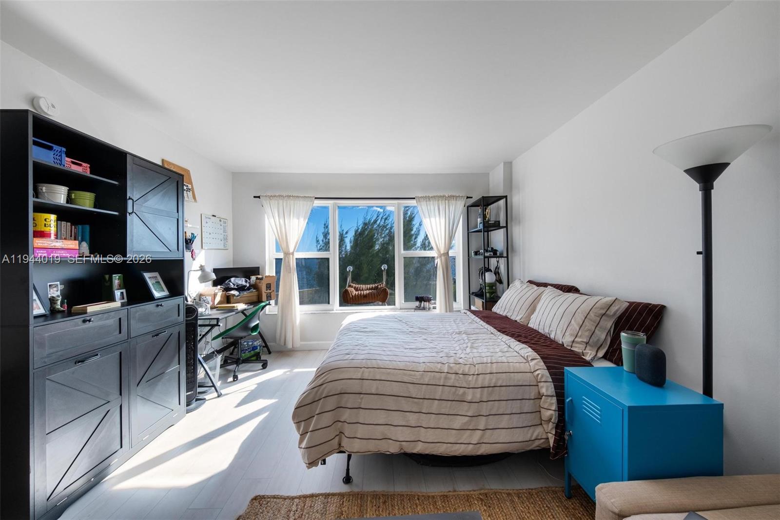 11111 Biscayne Boulevard, Unit 2D Miami, FL 33181 - Photo 20 of 26 a bedroom with bed and a couch