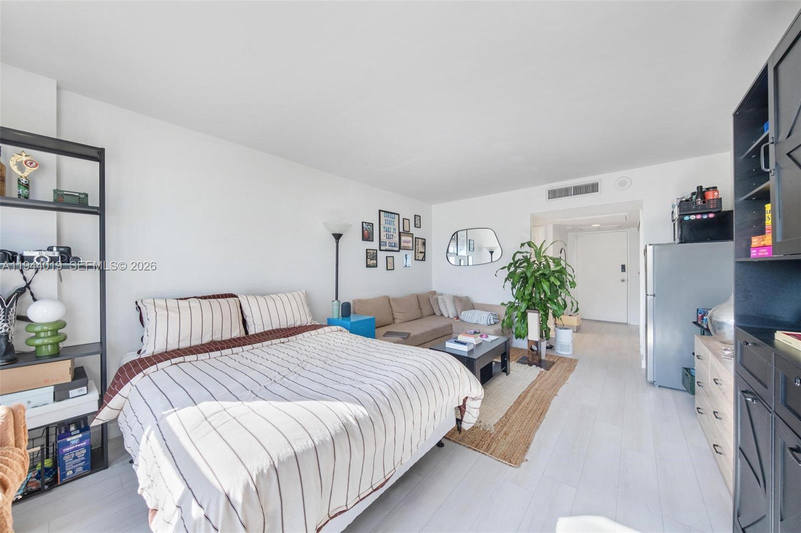 11111 Biscayne Boulevard, Unit 2D Miami, FL 33181 - Photo 21 of 26 a bedroom with two beds and potted plant on the dresser