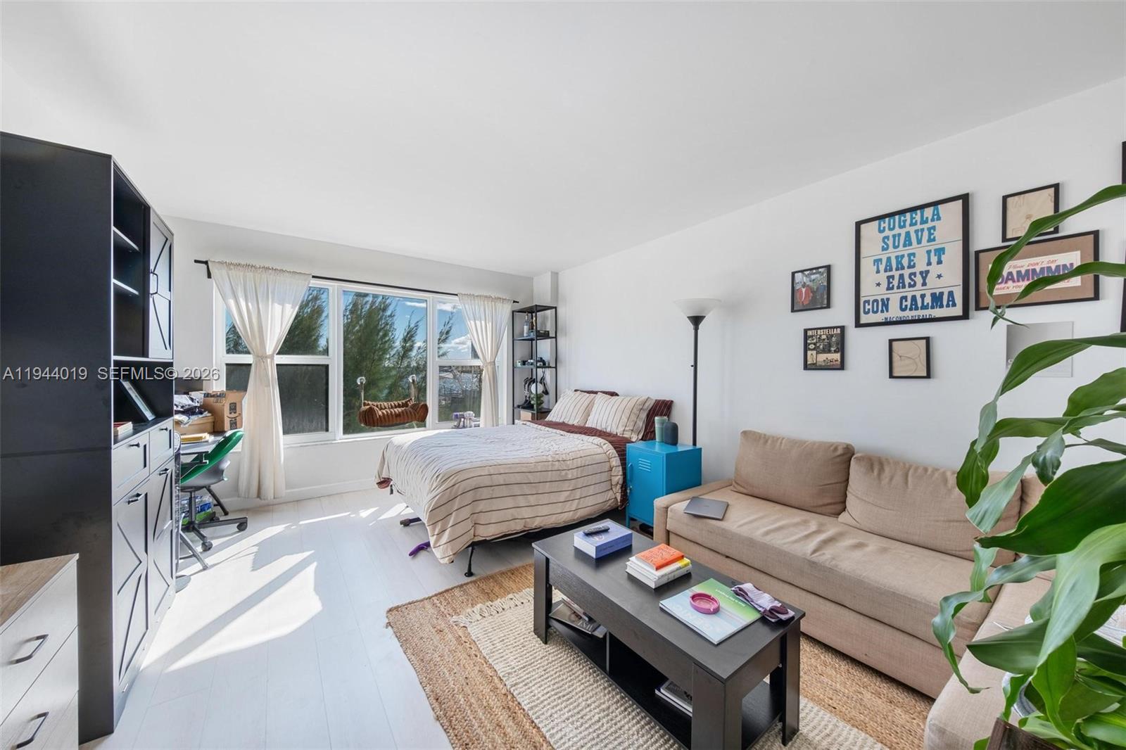 11111 Biscayne Boulevard, Unit 2D Miami, FL 33181 - Photo 22 of 26 a bedroom with furniture and a large window