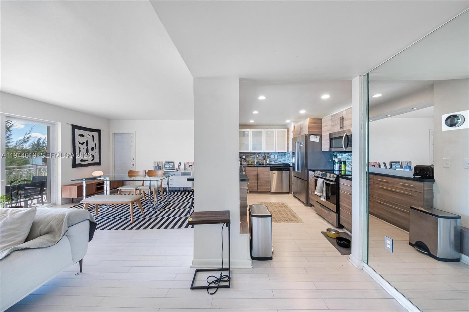 11111 Biscayne Boulevard, Unit 2D Miami, FL 33181 - Photo 7 of 26 a living room with furniture and a table