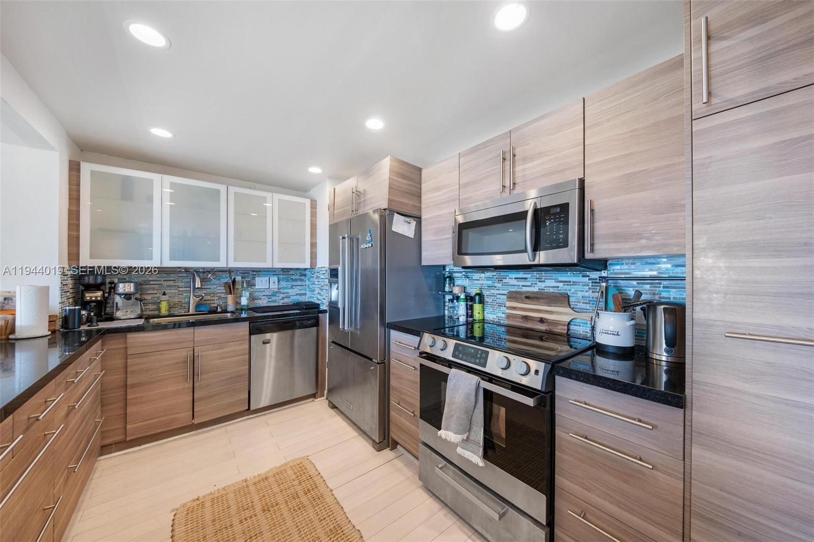 11111 Biscayne Boulevard, Unit 2D Miami, FL 33181 - Photo 10 of 26 a kitchen with stainless steel appliances granite countertop a stove and a sink
