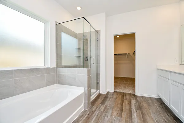 a bathroom with a bathtub and a shower