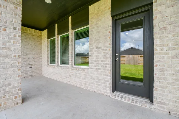a view of front door of house with a garden