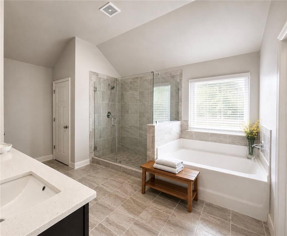 3359 Elkhorn Ridge Run Dacula, GA 30019 - Photo 29 of 35 a spacious bathroom with a bathtub and a shower