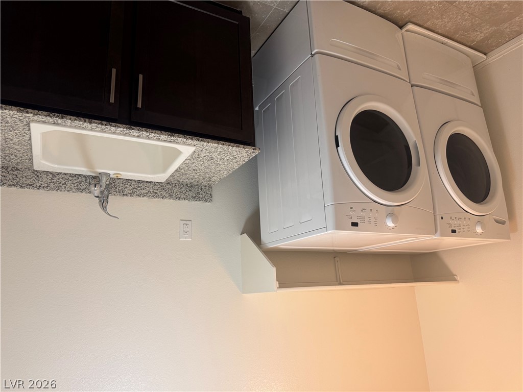 55 Canopus Ridge Way Las Vegas, NV 89183 - Photo 37 of 53 Functional laundry space showcases durable stone-look countertops and a built-in utility sink.