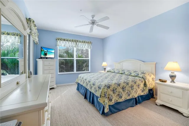 a bedroom with a large bed and a large window