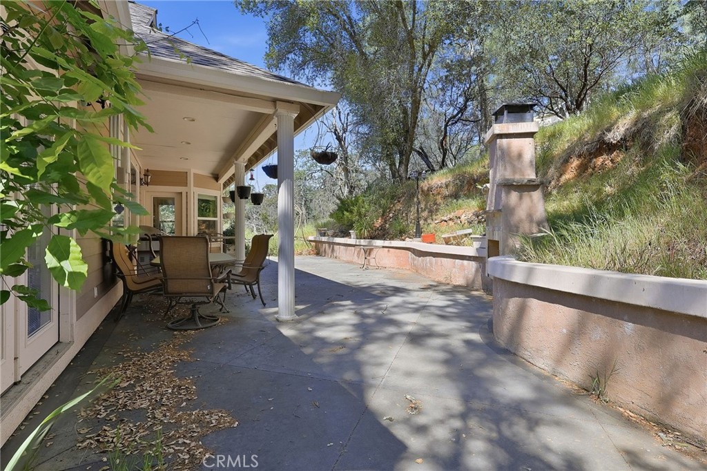 19370 Park Ridge Drive Hidden Valley Lake, CA 95467 - Photo 45 of 61 a view of a patio with table and chairs with wooden fence and plants
