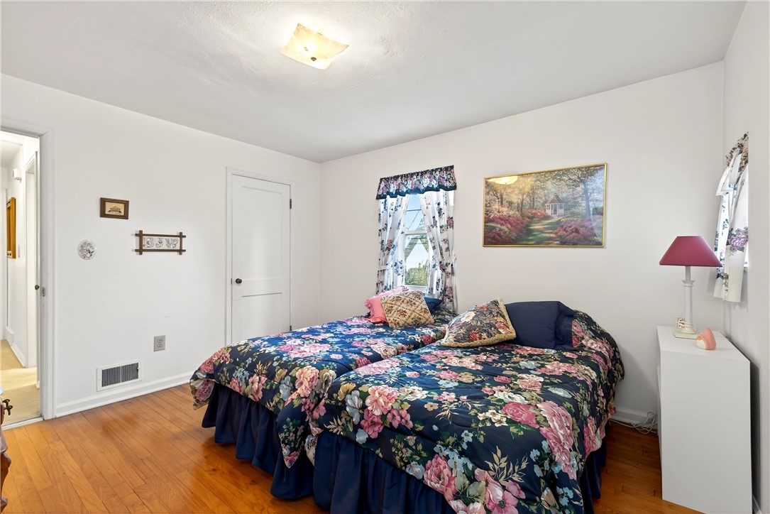 1237 Laurelwood Road Dayton, OH 45409 - Photo 23 of 56 This cozy bedroom features hardwood floors and a charming window, creating a serene and inviting atmosphere.