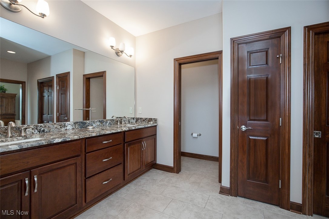 9155 Shank Road Litchfield, OH 44253 - Photo 18 of 47 Bathroom featuring double vanity and light tile patterned flooring
