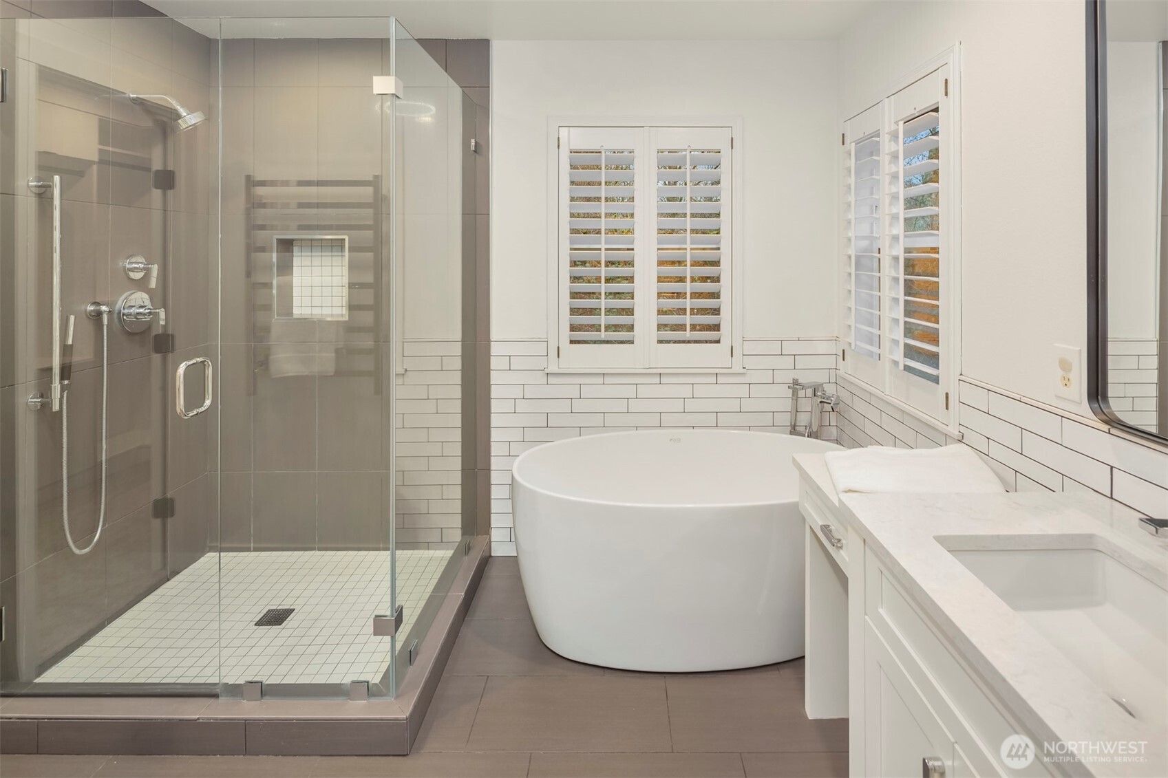 5819 Northeast 1st Street Renton, WA 98059 - Photo 27 of 38 a bathroom with a tub sink and a shower