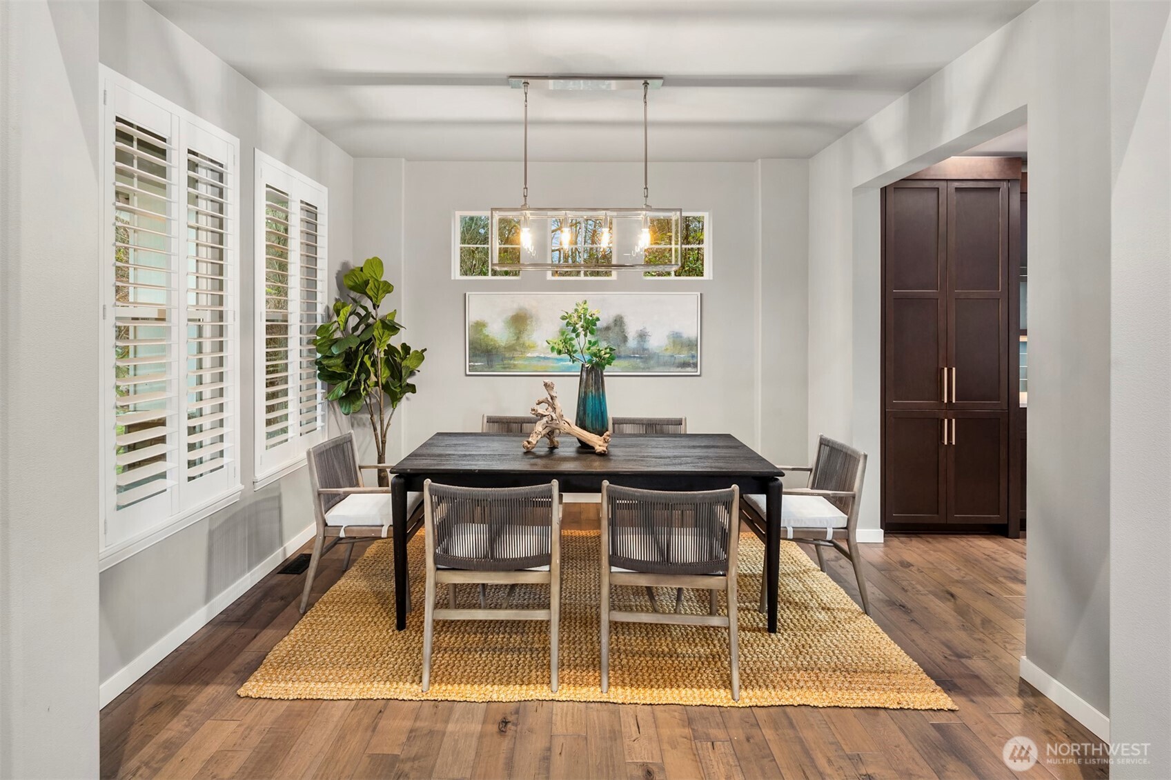 5819 Northeast 1st Street Renton, WA 98059 - Photo 4 of 38 a dining room with furniture a chandelier and wooden floor