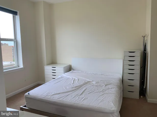 a bedroom with a bed and a window