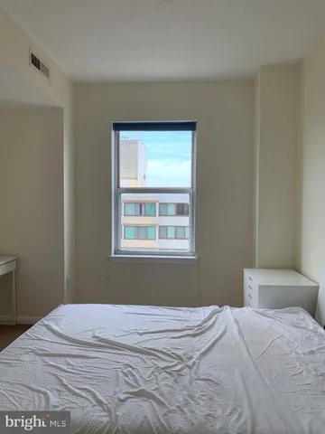 a bedroom with a bed and a window