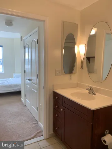 a en suite bathroom with a double vanity sink and a mirror