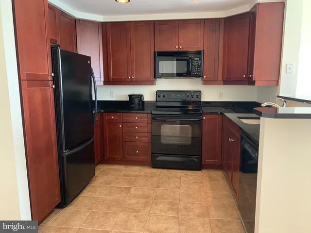 a kitchen with stainless steel appliances granite countertop a refrigerator stove and microwave