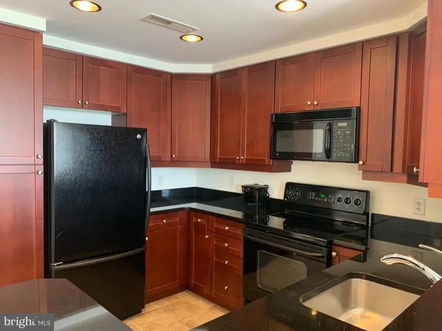 a kitchen with a refrigerator and a sink