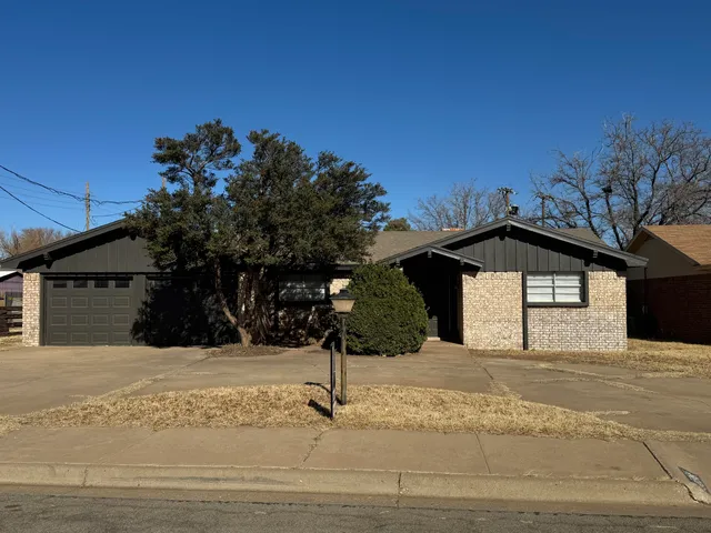 a view of a house with a snow in the yard