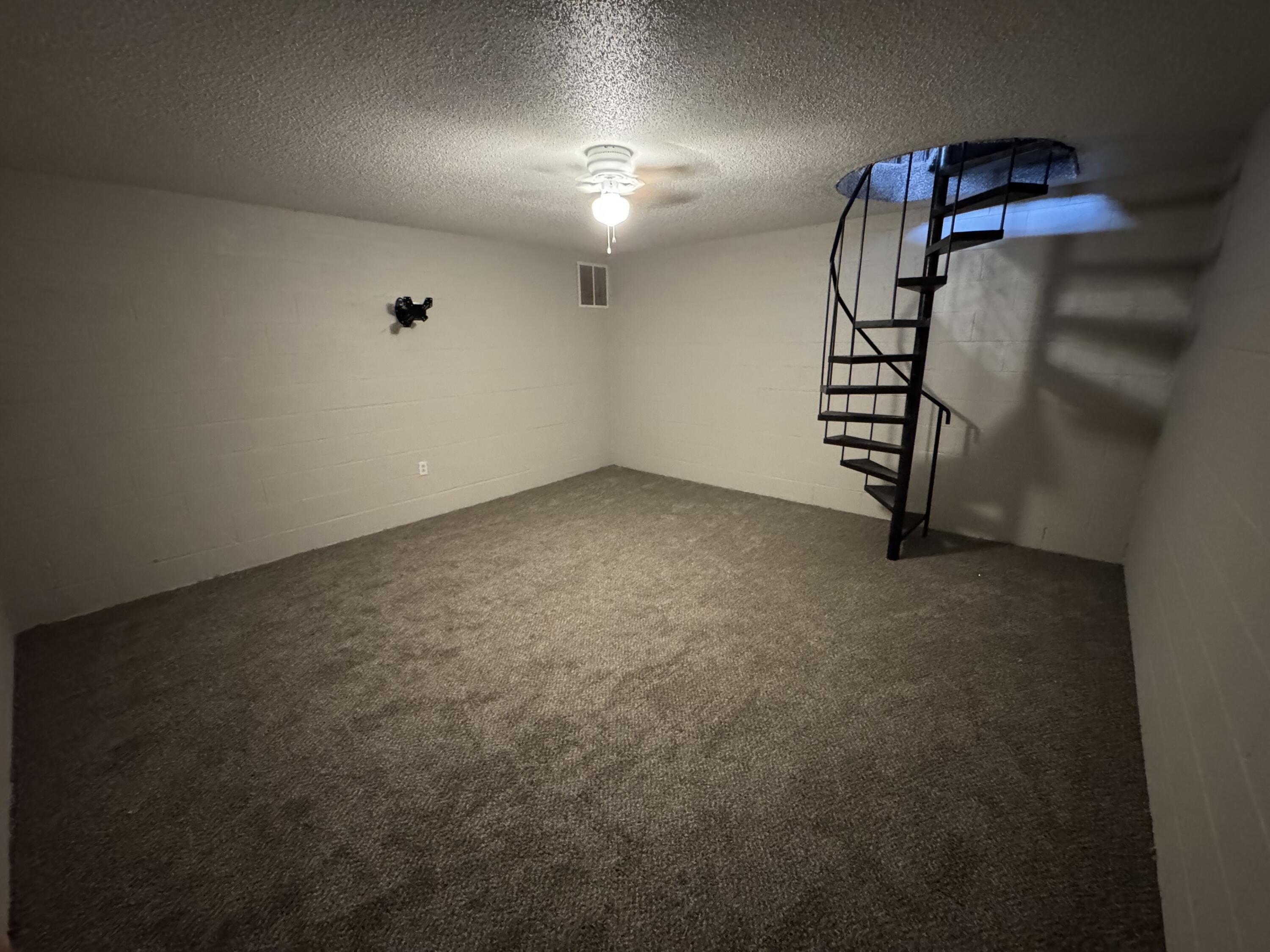 5236 17th Street Lubbock, TX 79416 - Photo 14 of 14 an empty room with windows and stairs
