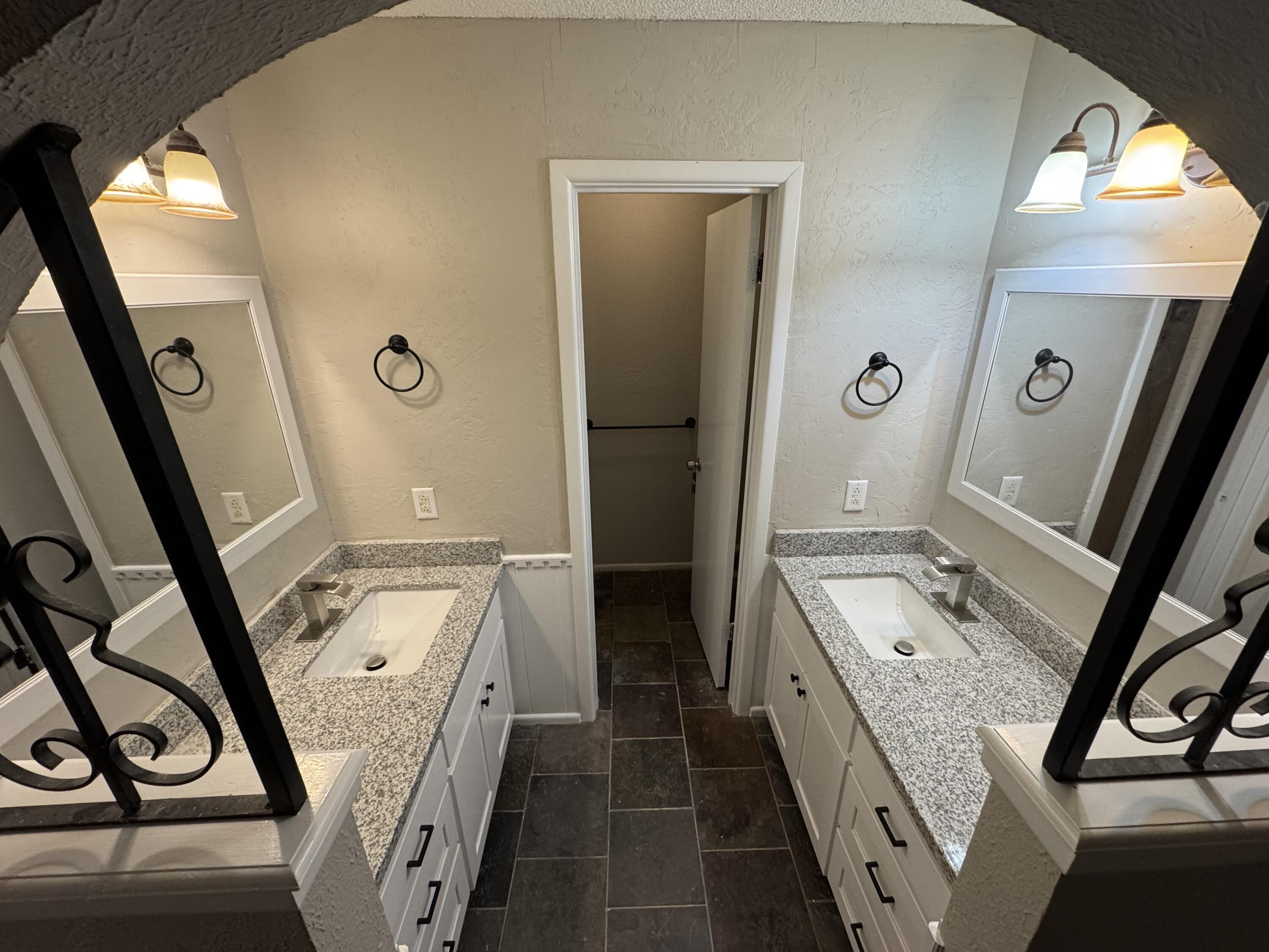 5236 17th Street Lubbock, TX 79416 - Photo 5 of 14 a bathroom with a double vanity sink and a mirror
