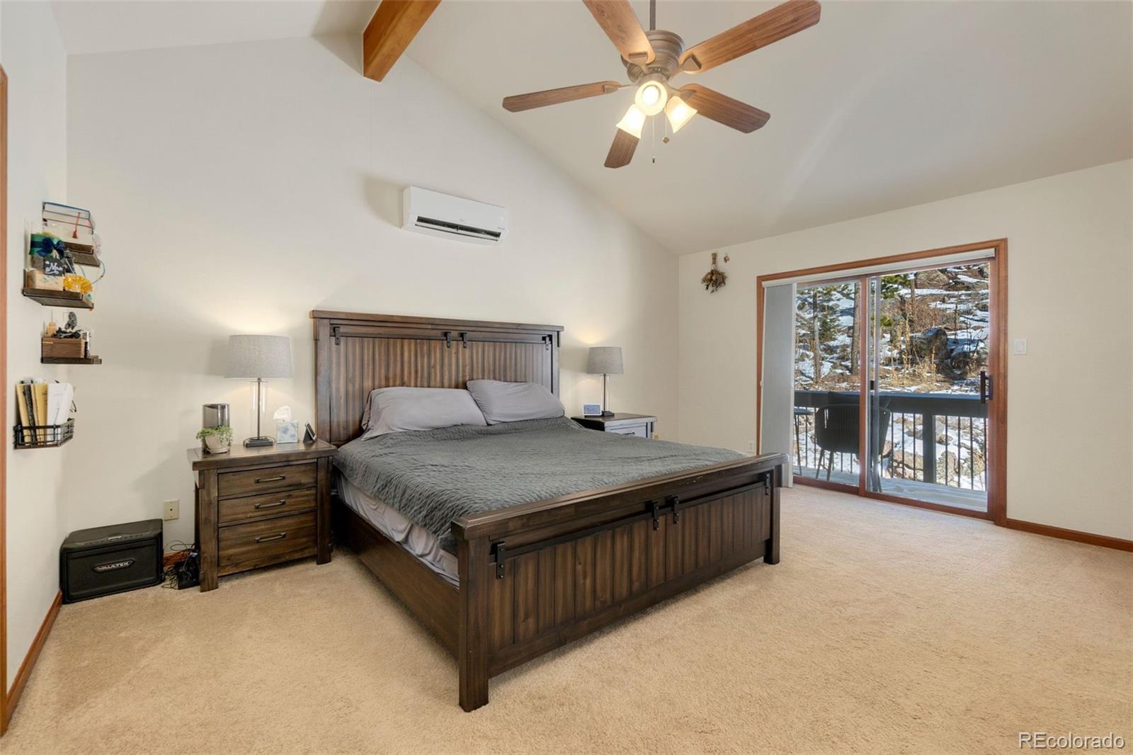33773 Elk Run Evergreen, CO 80439 - Photo 15 of 35 a bedroom with a large bed and a chandelier