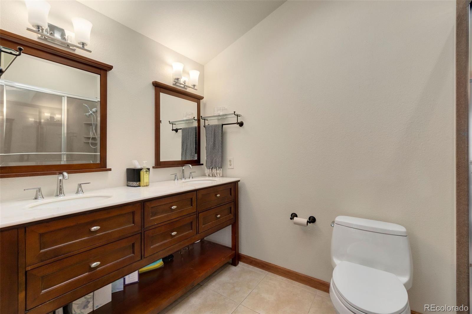 33773 Elk Run Evergreen, CO 80439 - Photo 17 of 35 a bathroom with a toilet a sink and mirror