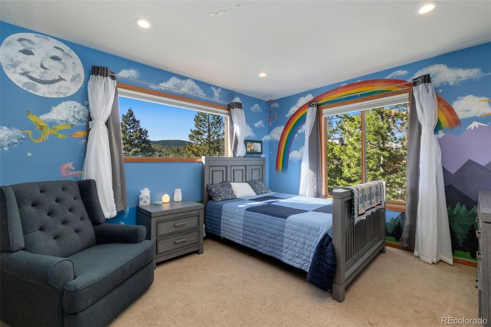 33773 Elk Run Evergreen, CO 80439 - Photo 18 of 35 a bedroom with a bed couch and a window