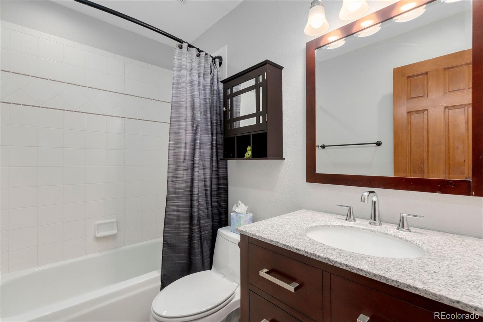 33773 Elk Run Evergreen, CO 80439 - Photo 20 of 35 a bathroom with a granite countertop sink toilet and shower
