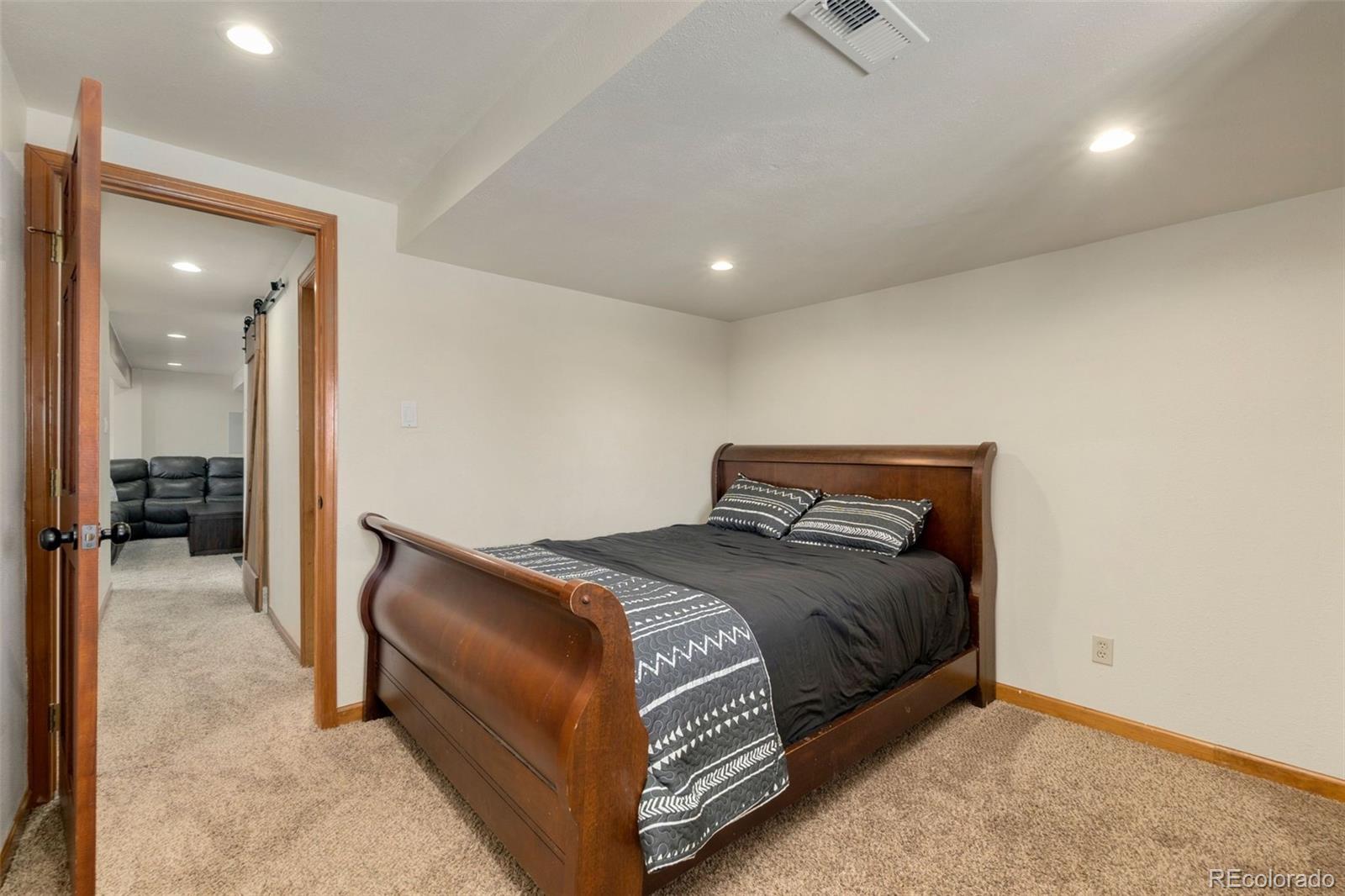 33773 Elk Run Evergreen, CO 80439 - Photo 21 of 35 a bedroom with a bed and a mirror
