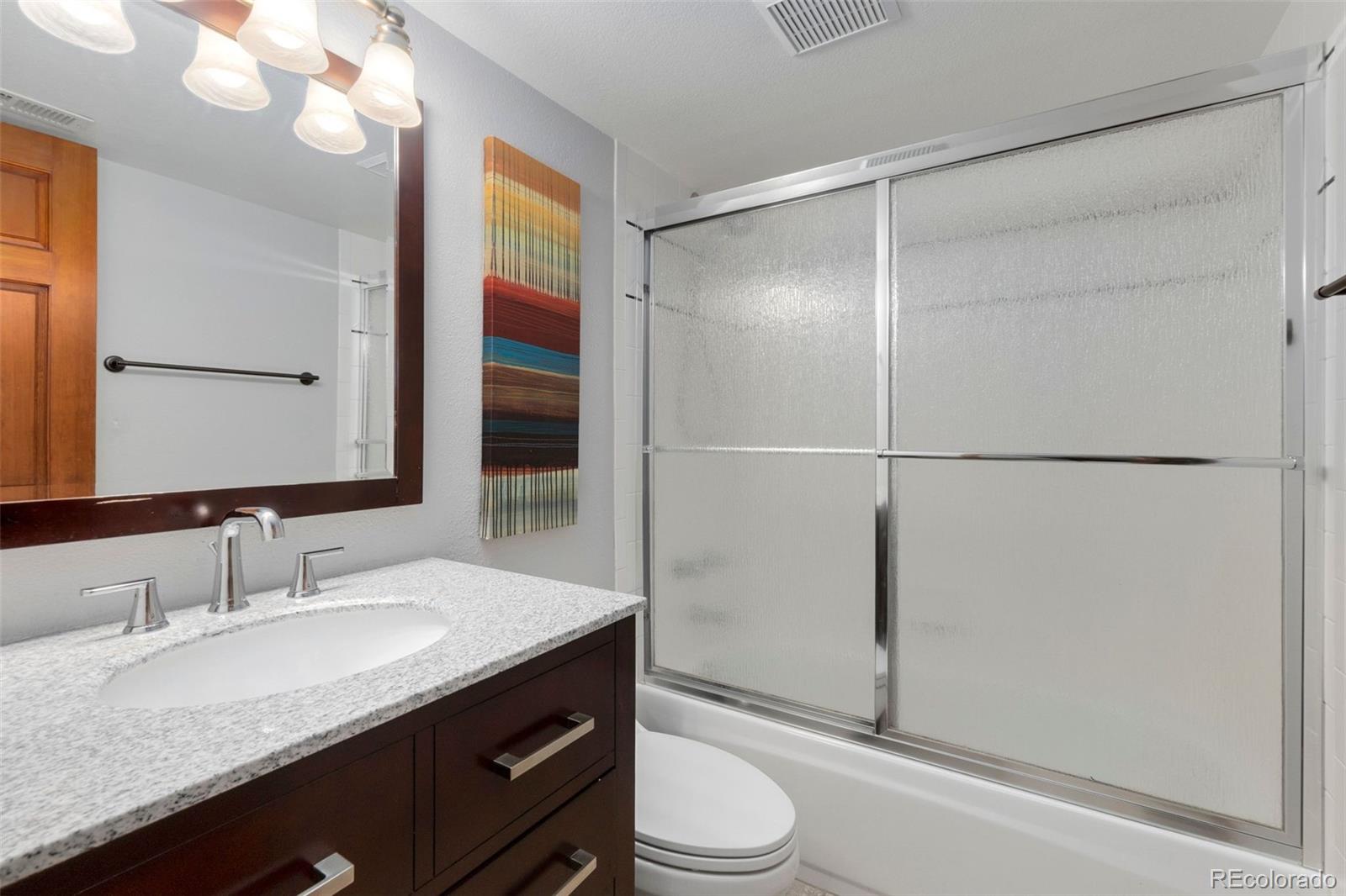 33773 Elk Run Evergreen, CO 80439 - Photo 24 of 35 a bathroom with a granite countertop sink toilet and shower