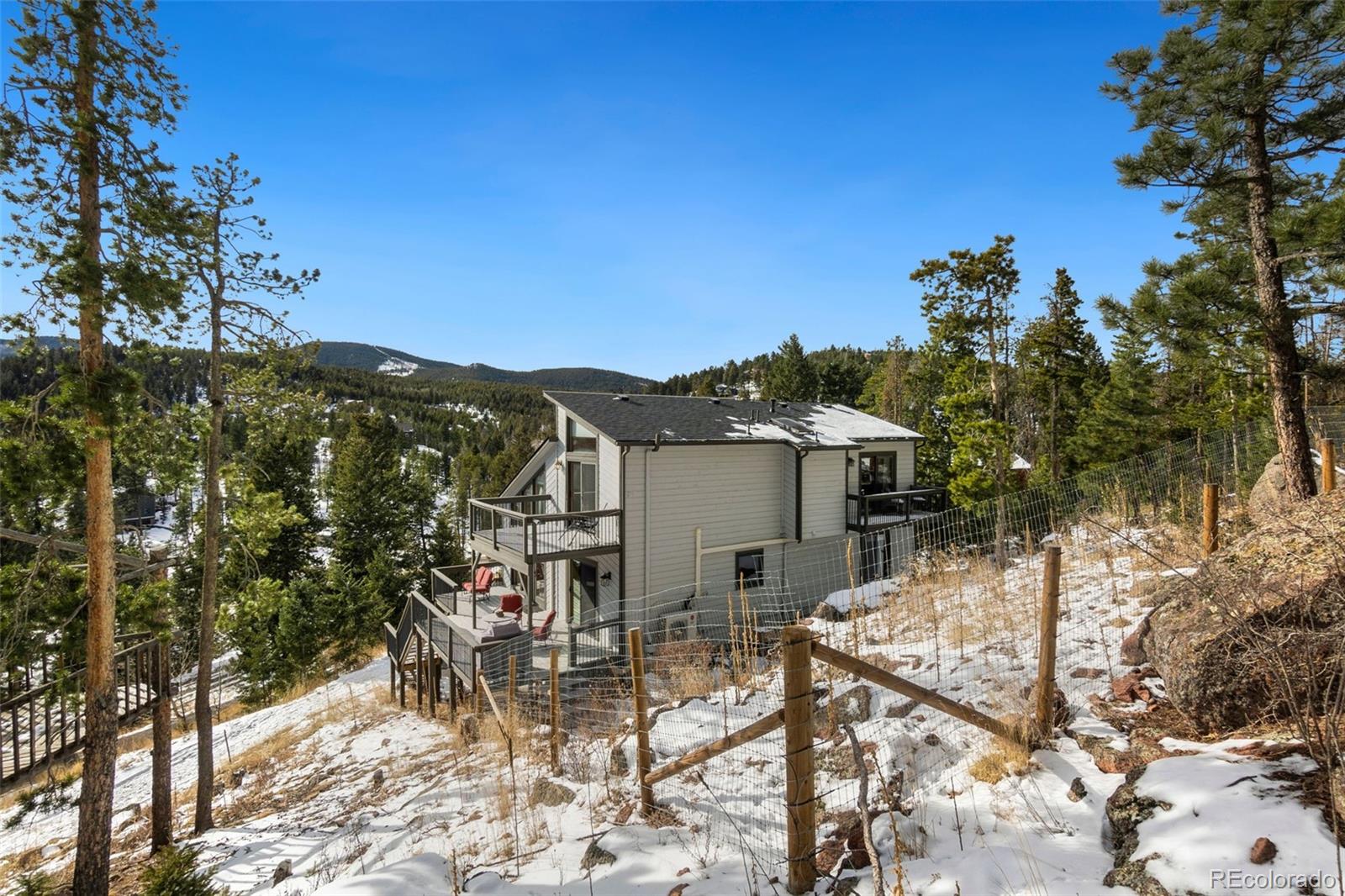 33773 Elk Run Evergreen, CO 80439 - Photo 26 of 35 a view of a house with a yard and sitting area