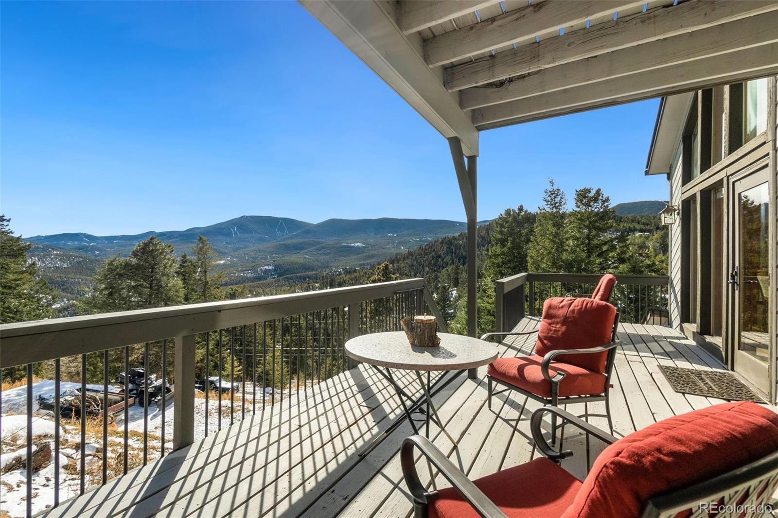 33773 Elk Run Evergreen, CO 80439 - Photo 4 of 35 a balcony with wooden floor table and chairs