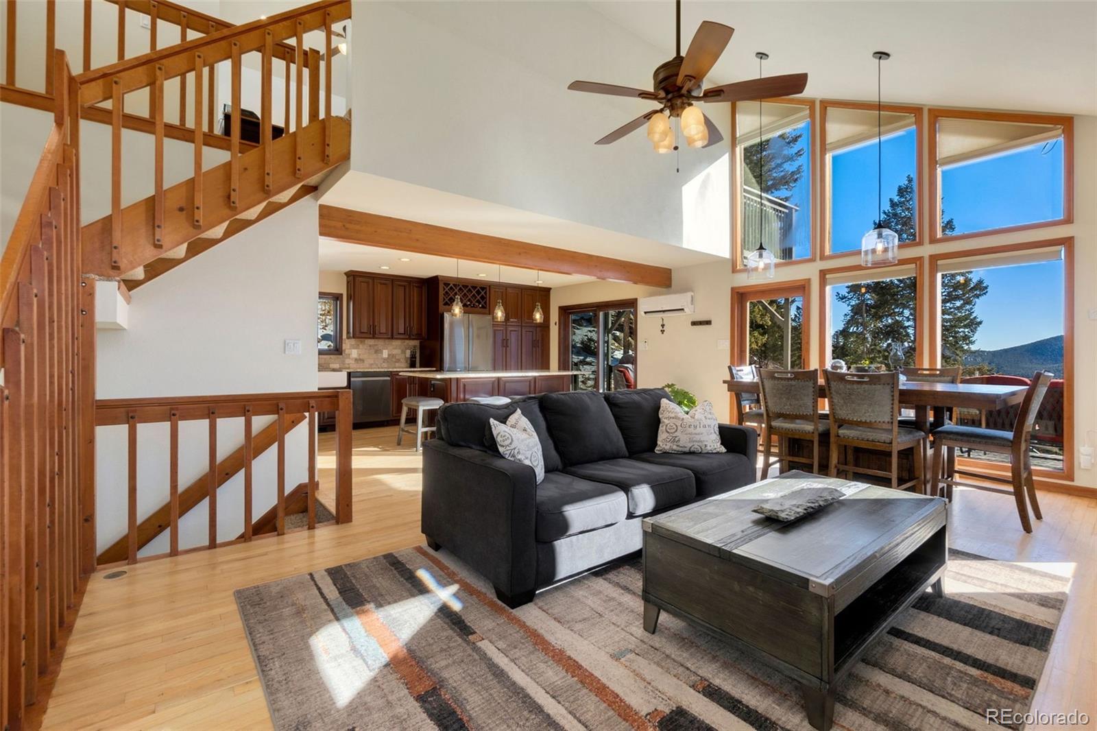 33773 Elk Run Evergreen, CO 80439 - Photo 7 of 35 a living room with furniture a rug and a chandelier