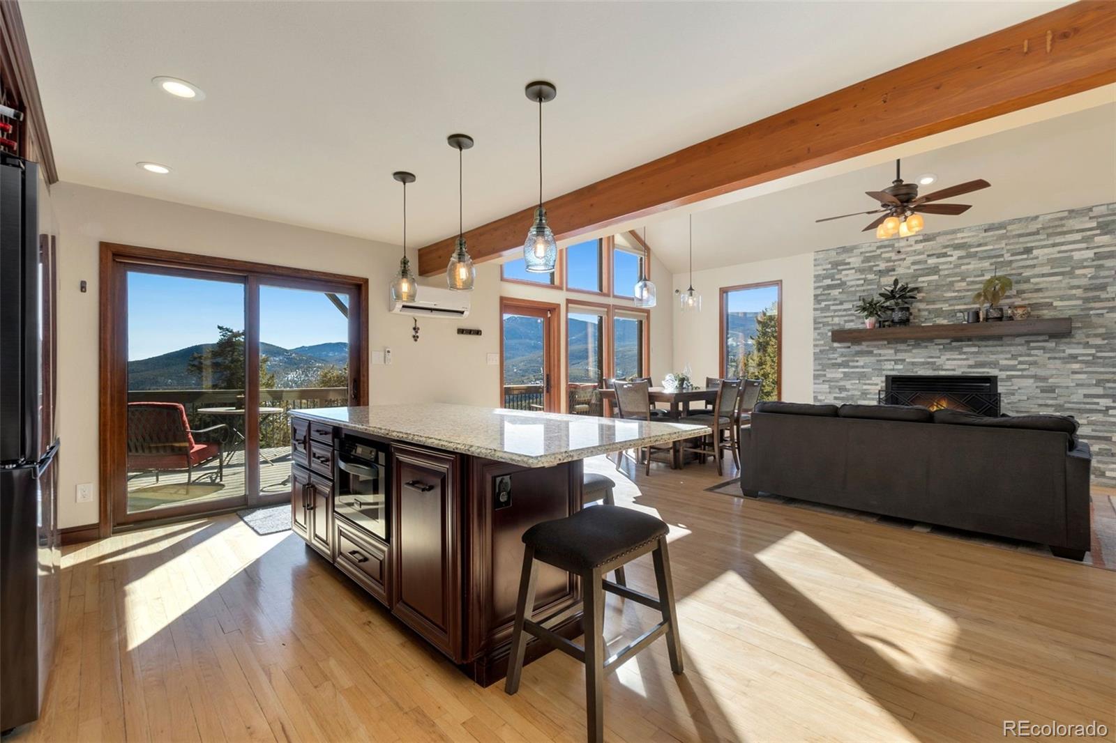 33773 Elk Run Evergreen, CO 80439 - Photo 8 of 35 a living room with fireplace furniture and a wooden floor