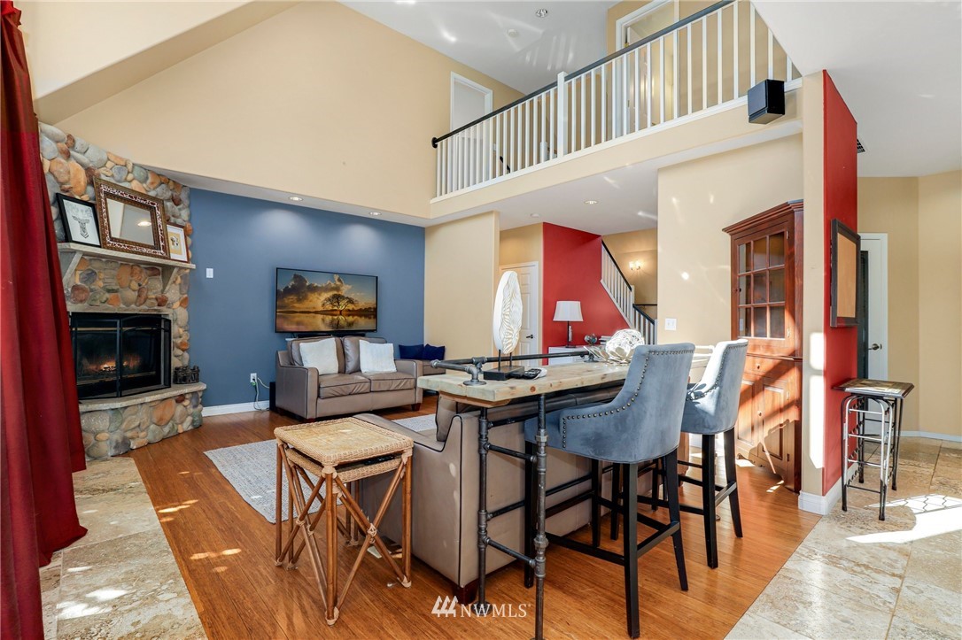 18318 Butler Road Snohomish, WA 98290 - Photo 10 of 25 a view of a dining room kitchen with furniture and a fireplace
