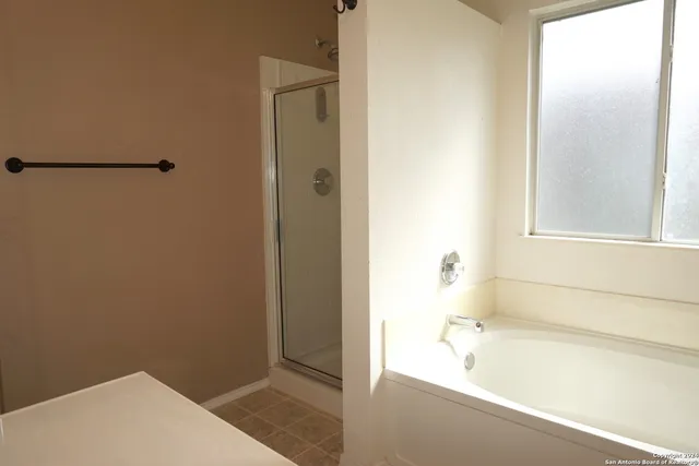 a bathroom with a bathtub and a shower