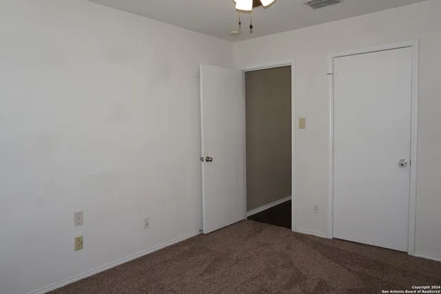 an empty room with closet area