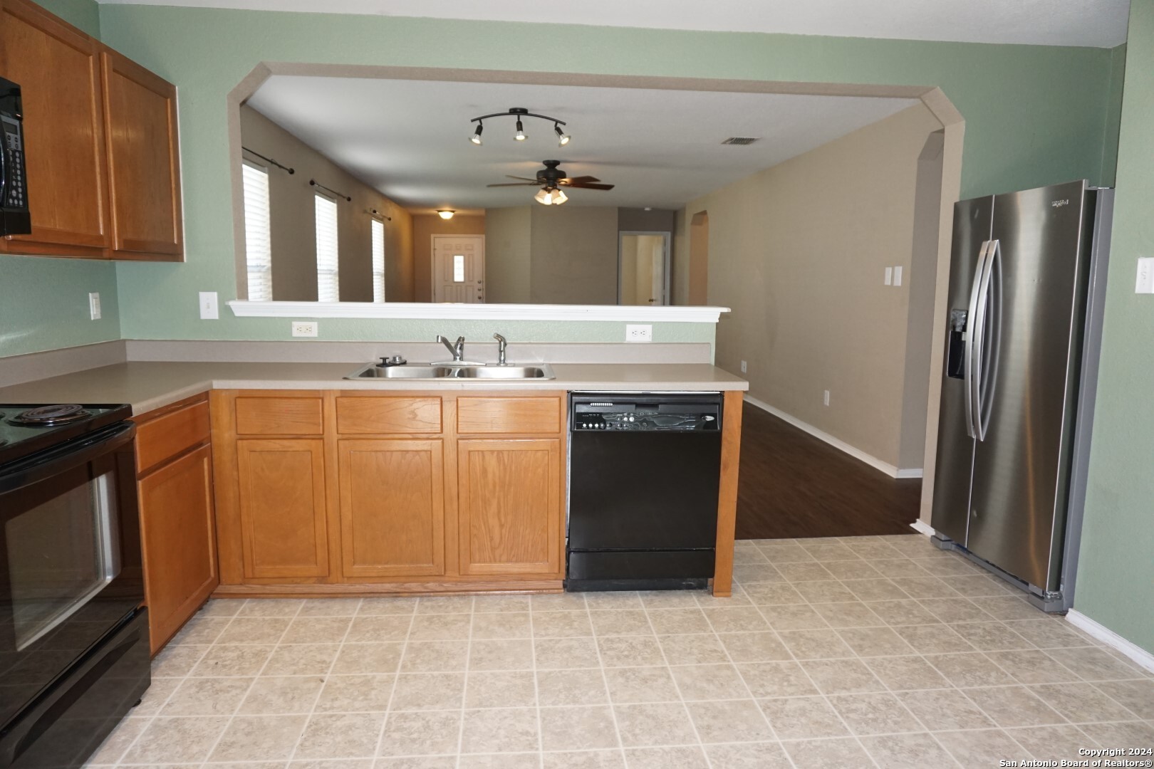 7730 Ruidoso Chase Selma, TX 78154 - Photo 6 of 22 a kitchen with stainless steel appliances granite countertop a stove a sink and a refrigerator