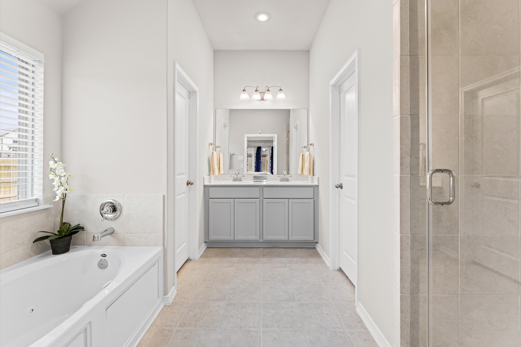 2702 Meadow View Lane Conroe, TX 77385 - Photo 13 of 26 a bathroom with a bathtub sink and mirror