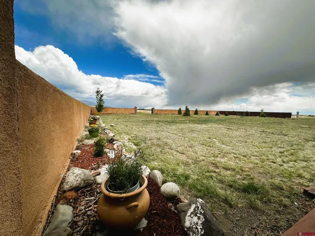 a sink with a vase and flowers on it