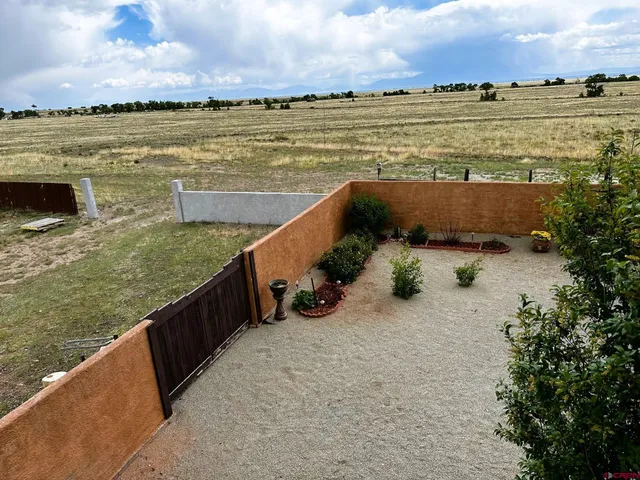 a backyard of a house with table and chairs