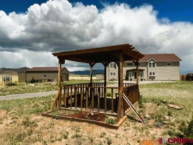 a front view of a house with pool table and chairs