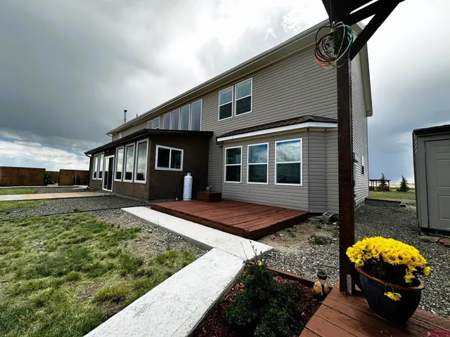 a view of a roof deck with couches and ocean view