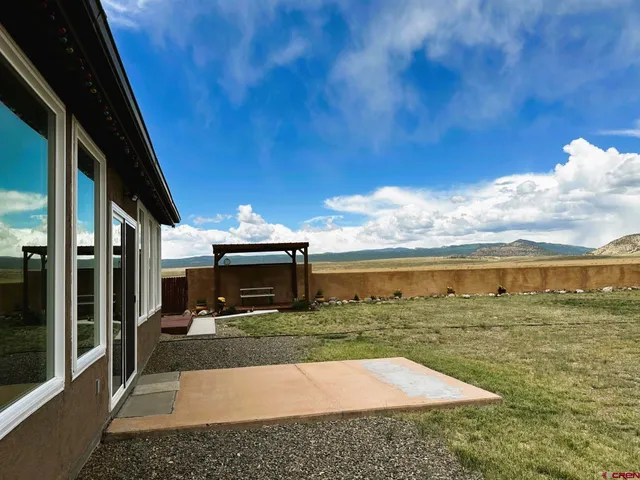 a front view of house with yard outdoor seating and barbeque oven