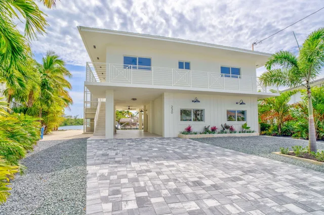 a view of a kitchen with kitchen island a sink stainless steel appliances and cabinets